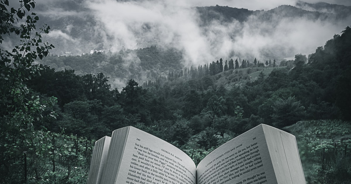 Small handmade scrapbook mini album open on a craft table with photos and embellishments